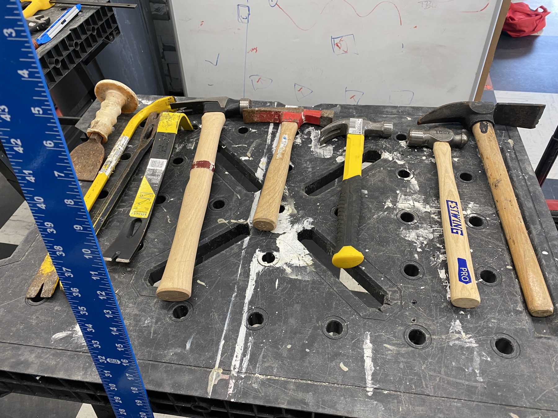 Hammers, levels and squares laid out on a workbench before a BTW session